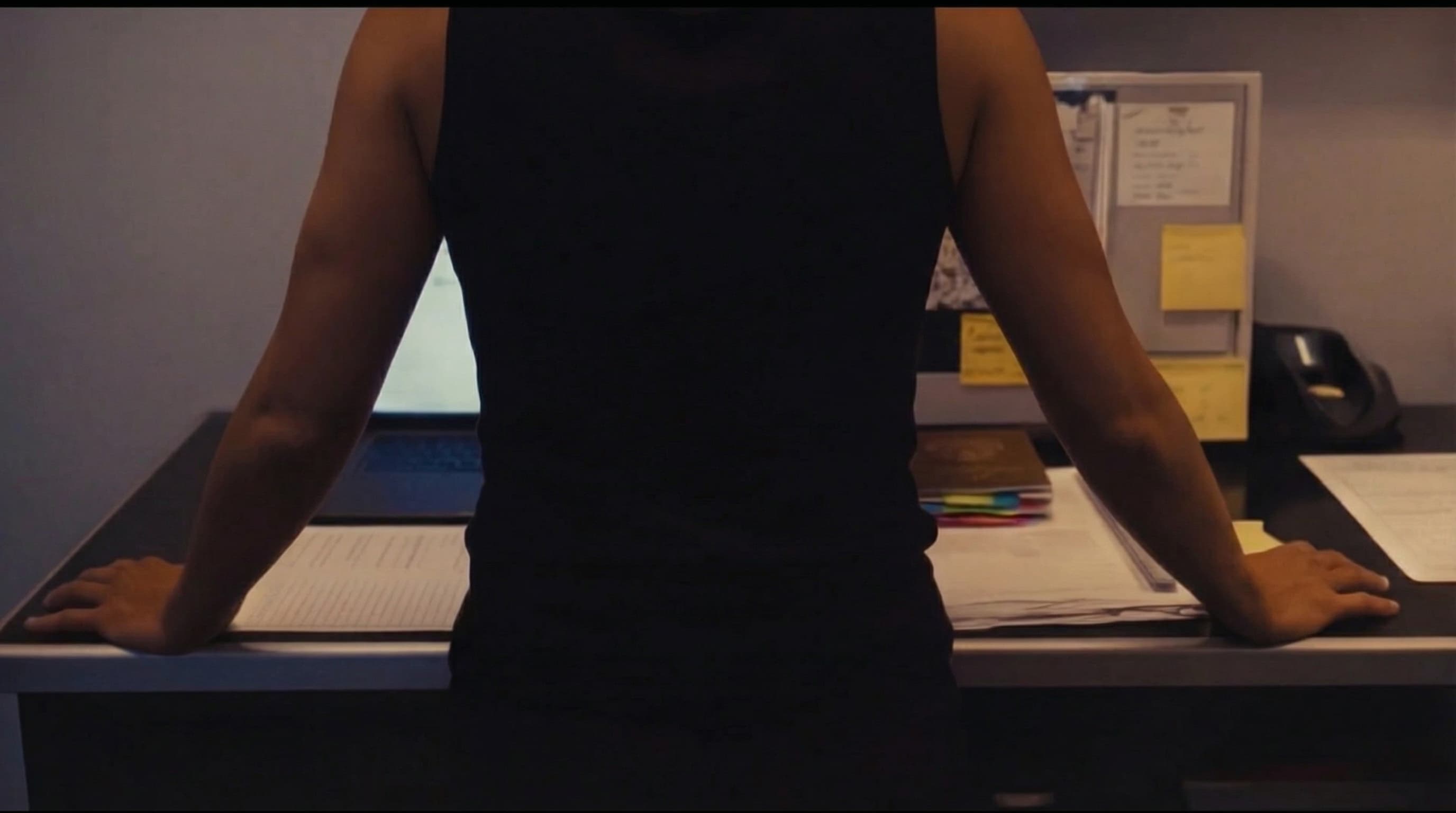 Crew member at desk — moody low-light